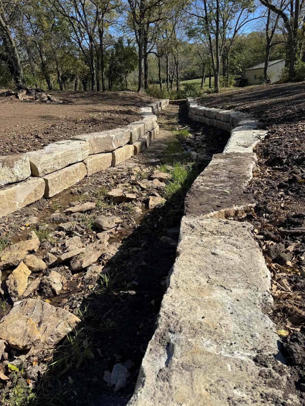 14" Sundown Ledge walls lining a backyard creek bed